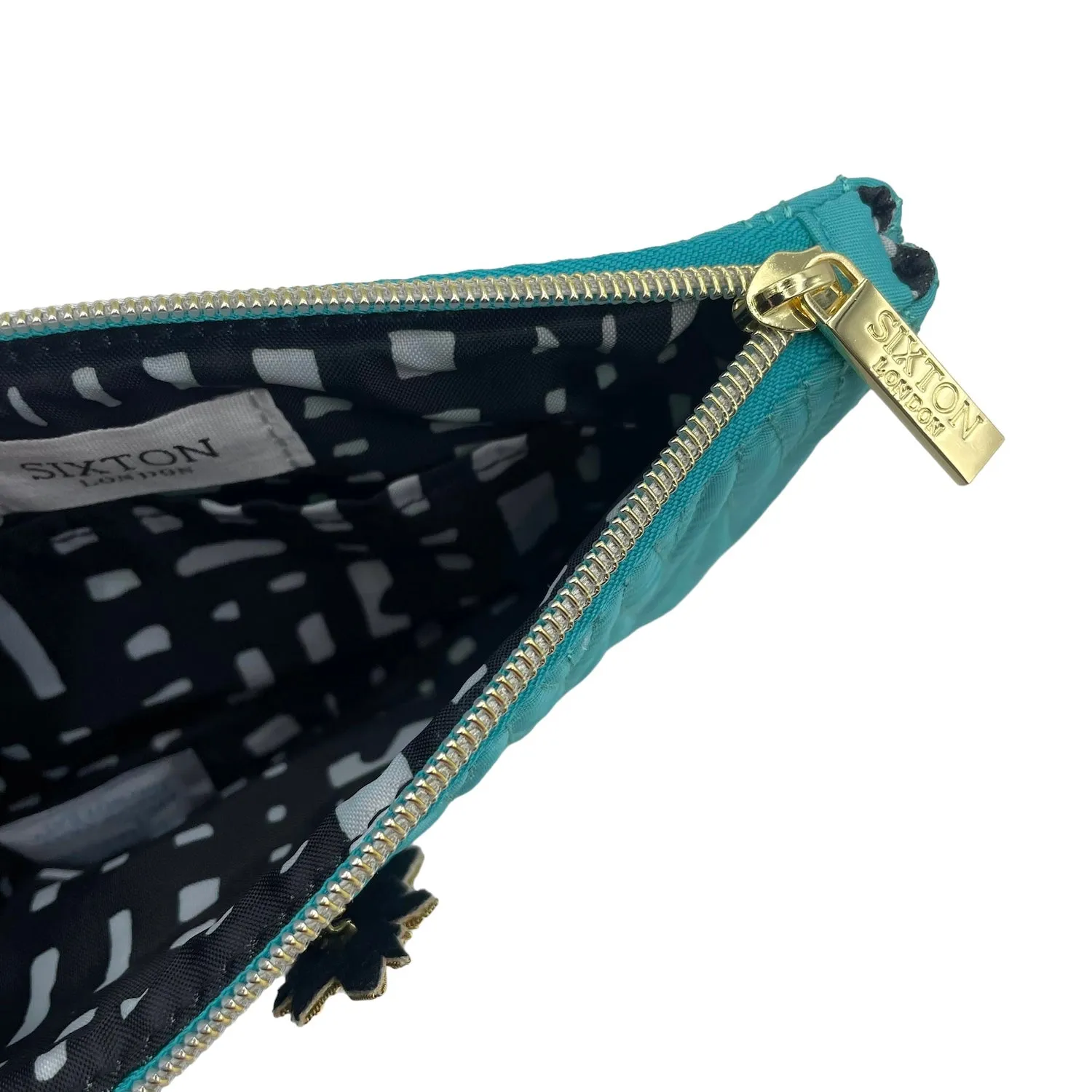 Turquoise Tribeca make up bag with a palm tree pin